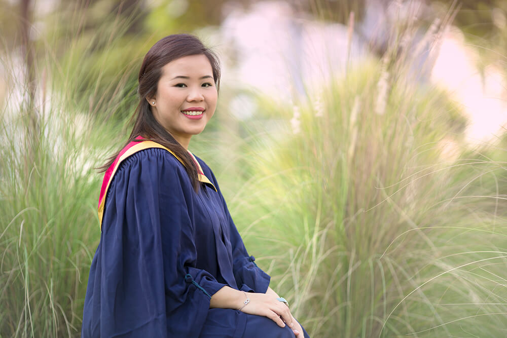 girl graduate with grass background