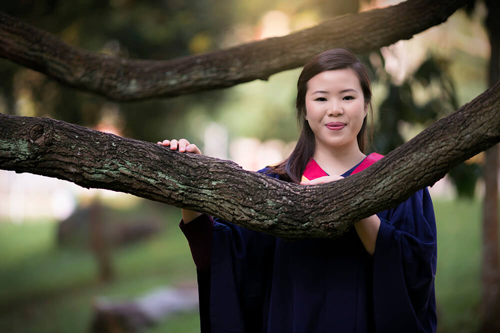 girl gradutaion tree branch