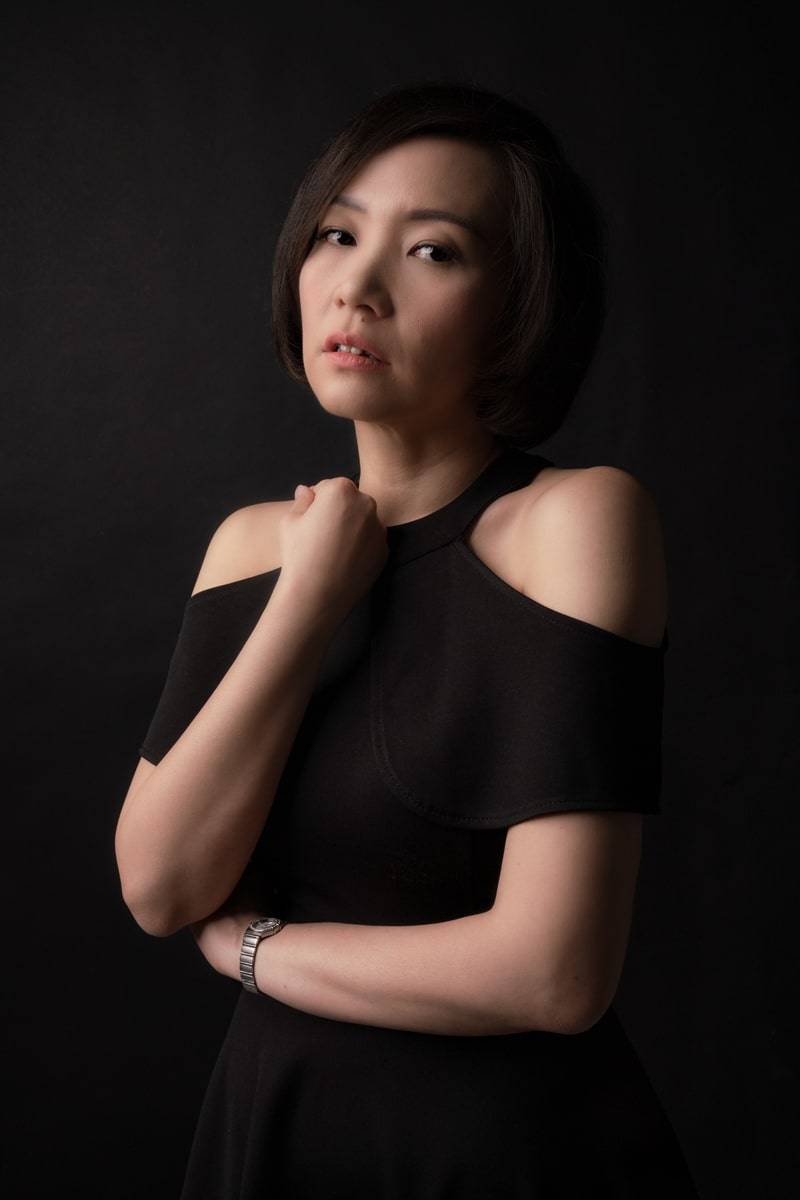 Stunning woman wearing a black dress poses for a captivating photo