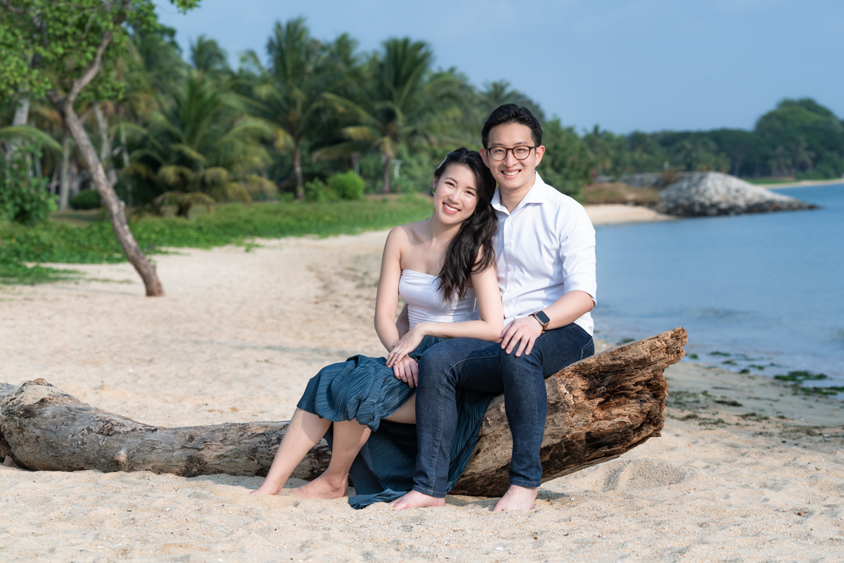 Smiling couple enjoying sandy beach