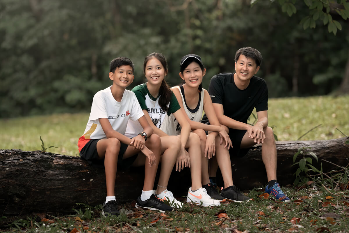 family sitting on a log