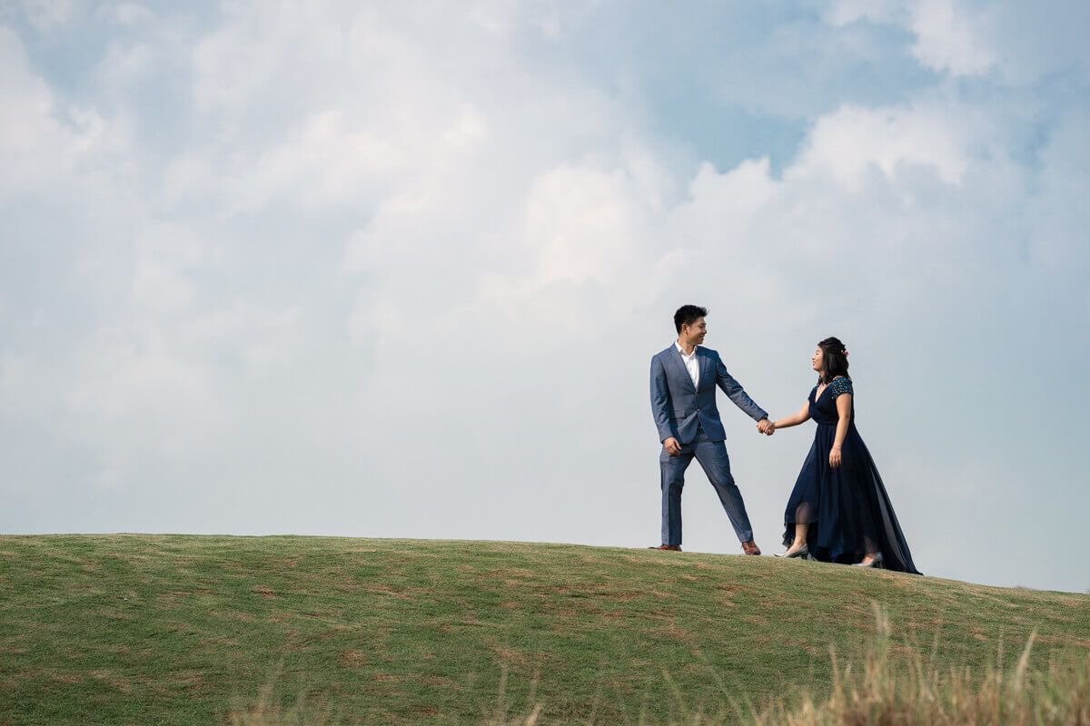 wedding couple walking hill top