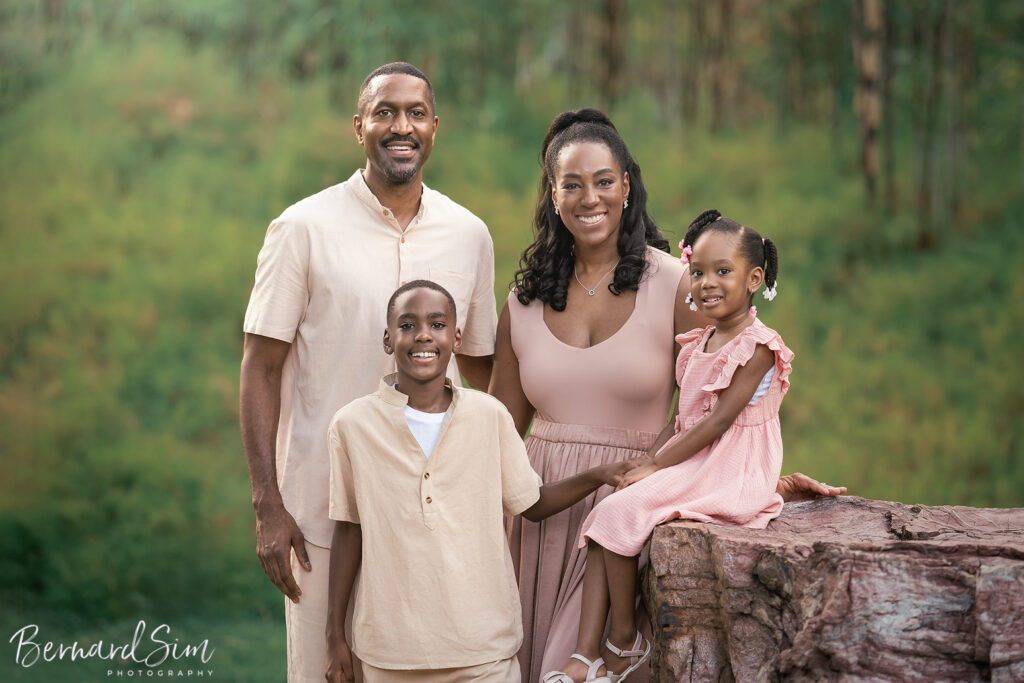 Smiling parents and children posing for a family photoshoot.